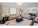 Spacious living room with neutral sofas, a coffee table, and a seamless flow to the kitchen and dining area at 1637 Dodford Ct, Wake Forest, NC 27587