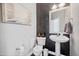 Elegant powder room with a pedestal sink, decorative wallpaper, and stylish decor at 1637 Dodford Ct, Wake Forest, NC 27587
