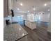 A kitchen with an island overlooks a large dining and living area with hardwood floors at 179 New Twin Branch Ct, Smithfield, NC 27577