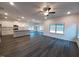 An open living room features hardwood floors, a ceiling fan and lots of natural light at 179 New Twin Branch Ct, Smithfield, NC 27577