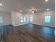 A living room with hardwood floors and multiple windows provides lots of natural light at 179 New Twin Branch Ct, Smithfield, NC 27577