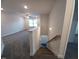 View of the carpeted staircase with white walls and railing to the second floor of the home at 179 New Twin Branch Ct, Smithfield, NC 27577
