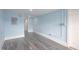 Basement area features light blue walls, gray laminate flooring, and recessed lighting at 1917 Tucker St, Burlington, NC 27215