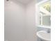 Modern bathroom with white subway tiles, a window, and a pedestal sink at 1917 Tucker St, Burlington, NC 27215