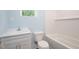 Renovated bathroom with white fixtures, a tub, and tiled walls at 1917 Tucker St, Burlington, NC 27215