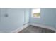Spacious bedroom with gray wood-look flooring and light blue walls at 1917 Tucker St, Burlington, NC 27215