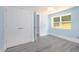 Spacious bedroom featuring light blue walls, closet doors, and gray laminate flooring at 1917 Tucker St, Burlington, NC 27215