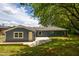 Rear exterior view of the home showcasing a patio, fresh paint, and a well-maintained backyard at 1917 Tucker St, Burlington, NC 27215
