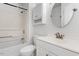 Well-lit bathroom featuring a tub-shower combo, vanity with sink, and round mirror at 192 Summerwalk Cir, Chapel Hill, NC 27517