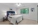 Cozy bedroom with plush bedding, bedside table, and a window overlooking the greenery at 192 Summerwalk Cir, Chapel Hill, NC 27517