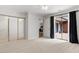 Spacious bedroom with sliding glass doors to deck, mirrored closet, and neutral carpet at 192 Summerwalk Cir, Chapel Hill, NC 27517