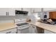 Kitchen with stove, hood, and peninsula with views to the living spaces at 192 Summerwalk Cir, Chapel Hill, NC 27517