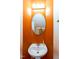 Powder room featuring a pedestal sink, oval mirror, and bright orange walls at 1937 Crag Burn Ln, Raleigh, NC 27604