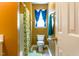 Comfortable bathroom featuring a tub with shower, neutral walls, and a single window at 1937 Crag Burn Ln, Raleigh, NC 27604
