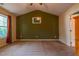 Spacious bedroom featuring neutral carpeting, olive accent wall, and vaulted ceiling at 1937 Crag Burn Ln, Raleigh, NC 27604