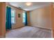 Large bedroom features neutral carpeting, two windows with curtains, and light-colored walls at 1937 Crag Burn Ln, Raleigh, NC 27604