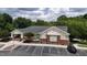 Exterior shot of a clubhouse with ample parking, landscaped grounds, and covered entrance at 1937 Crag Burn Ln, Raleigh, NC 27604