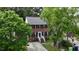 Aerial view of a traditional two-story brick house with green trees surrounding the property at 1937 Crag Burn Ln, Raleigh, NC 27604