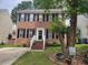 Charming two-story brick home with black shutters, a manicured lawn, and mature trees at 1937 Crag Burn Ln, Raleigh, NC 27604