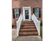 Inviting front entrance with brick steps, white railings, and a decorative door at 1937 Crag Burn Ln, Raleigh, NC 27604
