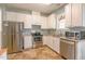Well-lit kitchen with stainless steel appliances, granite countertops, and white cabinets at 1937 Crag Burn Ln, Raleigh, NC 27604