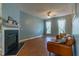 Cozy living room with a fireplace, ceiling fan, and comfortable seating at 1937 Crag Burn Ln, Raleigh, NC 27604