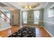 Elegant living room with hardwood floors, crown molding, and a stylish chandelier at 1937 Crag Burn Ln, Raleigh, NC 27604