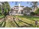Back exterior view of home with a large chimney, stone feature, and mature landscaping at 20007 Bragg, Chapel Hill, NC 27517