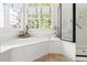Bright bathroom with tub under a window at 20007 Bragg, Chapel Hill, NC 27517