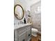 Bathroom featuring patterned wallpaper, a round window, and a white marble countertop at 20007 Bragg, Chapel Hill, NC 27517