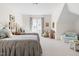 Bright bedroom featuring twin beds with plush linens, sitting area, and sunny window at 20007 Bragg, Chapel Hill, NC 27517