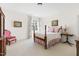 Bedroom with a four-poster bed, wood side table, floral linens, and decor at 20007 Bragg, Chapel Hill, NC 27517