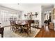 Elegant dining room with hardwood floors, large window, a chandelier, and seating for ten at 20007 Bragg, Chapel Hill, NC 27517