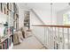 Hallway landing with railing and built-in bookshelves at 20007 Bragg, Chapel Hill, NC 27517