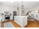 Bright kitchen with an island and seating area, stainless steel appliances, and hardwood floors at 20007 Bragg, Chapel Hill, NC 27517
