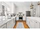 Bright kitchen featuring white countertops, stainless steel appliances, and hardwood floors at 20007 Bragg, Chapel Hill, NC 27517