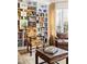 Cozy living room with built-in bookshelves, patterned armchairs, and a large window at 20007 Bragg, Chapel Hill, NC 27517