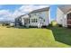 A spacious backyard with a pristine lawn, a screened porch, and a deck off the back of the house at 208 Dry Canyon Dr, Wendell, NC 27591