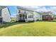 Lush green backyard with a screened-in porch and a deck, perfect for outdoor enjoyment and relaxation at 208 Dry Canyon Dr, Wendell, NC 27591