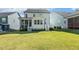 A verdant, well-maintained lawn with an inviting backyard, screened porch, and a small deck at 208 Dry Canyon Dr, Wendell, NC 27591