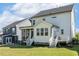 A well-maintained backyard with a screened porch and a small deck with steps leading to the lawn at 208 Dry Canyon Dr, Wendell, NC 27591