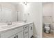 Modern bathroom with double sinks, sleek white cabinets, and a separate toilet area at 208 Dry Canyon Dr, Wendell, NC 27591