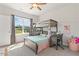 Bright bedroom with a wooden bunk bed, study desk, large window, and plush carpeting at 208 Dry Canyon Dr, Wendell, NC 27591