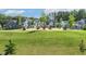 Inviting community common area with Adirondack chairs arranged in small clusters on the grass at 208 Dry Canyon Dr, Wendell, NC 27591