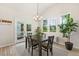 Dining room with natural light, view to the screened in porch, and modern lighting at 208 Dry Canyon Dr, Wendell, NC 27591