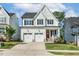 Beautiful two-story home featuring a two-car garage, a red front door, and a well-manicured lawn at 208 Dry Canyon Dr, Wendell, NC 27591