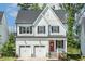 Charming two-story home featuring a two-car garage, a red front door, and a well-manicured lawn at 208 Dry Canyon Dr, Wendell, NC 27591