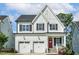 Charming two-story home featuring a two-car garage, a red front door, and a well-manicured lawn at 208 Dry Canyon Dr, Wendell, NC 27591