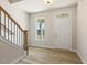 Bright foyer with hardwood floors, a staircase, and a view through the window creates a welcoming ambiance at 208 Dry Canyon Dr, Wendell, NC 27591