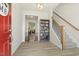 Bright foyer with hardwood floors, a staircase, and a view into the living room creates a welcoming ambiance at 208 Dry Canyon Dr, Wendell, NC 27591
